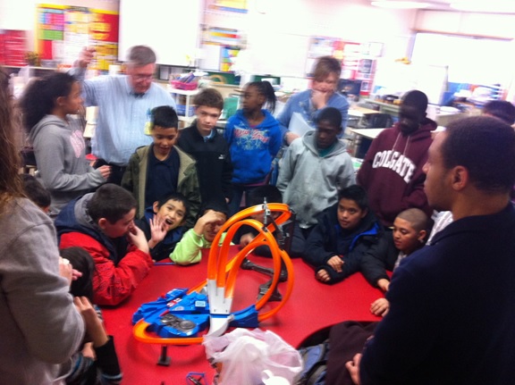 My teammates and me showing students a Hotwheels track.